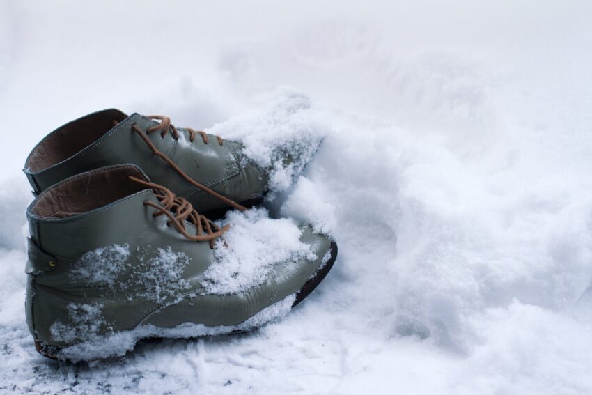vintage leather shoes covered in snow