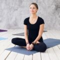 Woman practicing meditation at a yoga studio